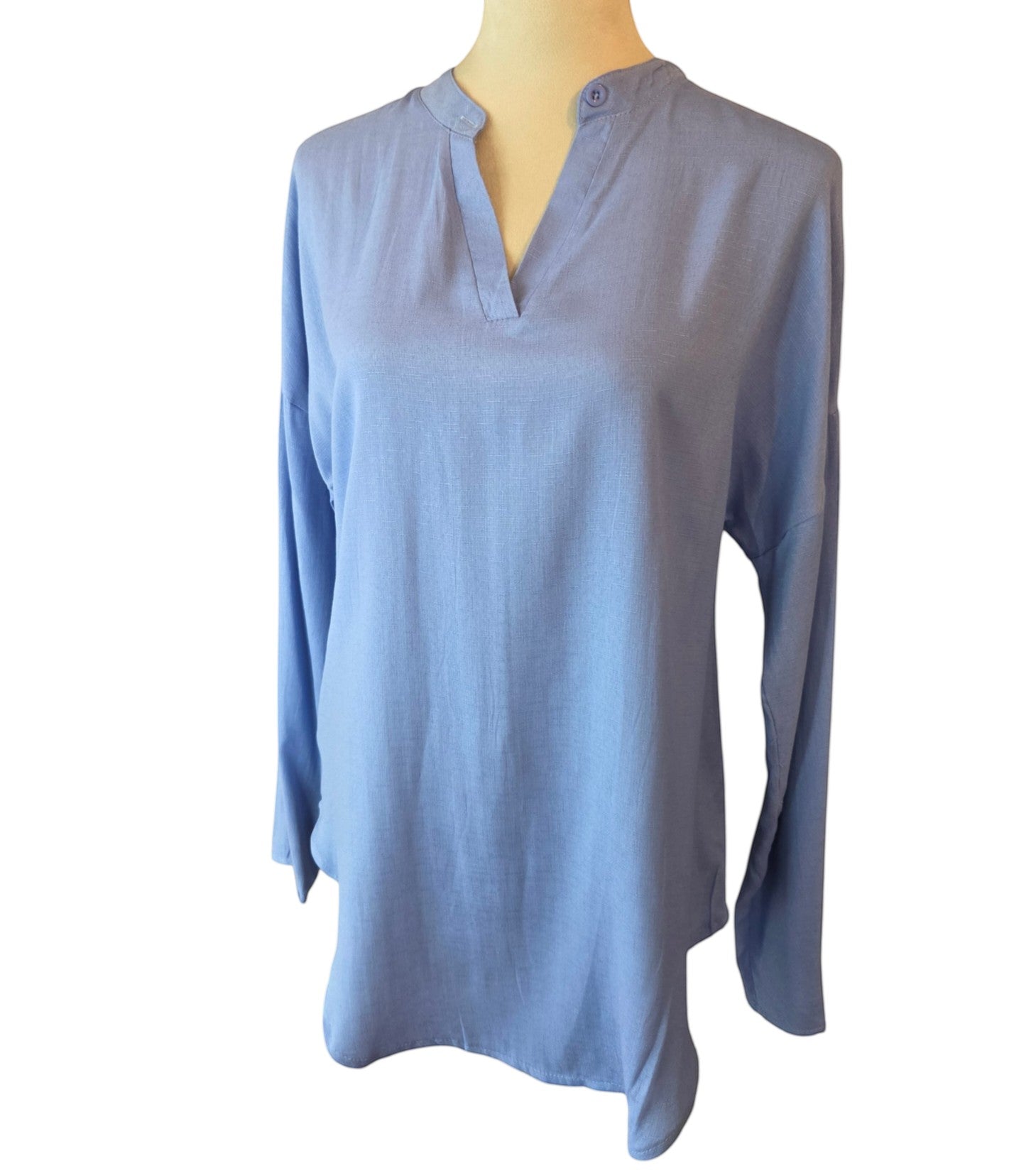 Birds of a Feather Boutique & Soy Wax Candle Company light blue long sleeve tunic with a split neckline and button.