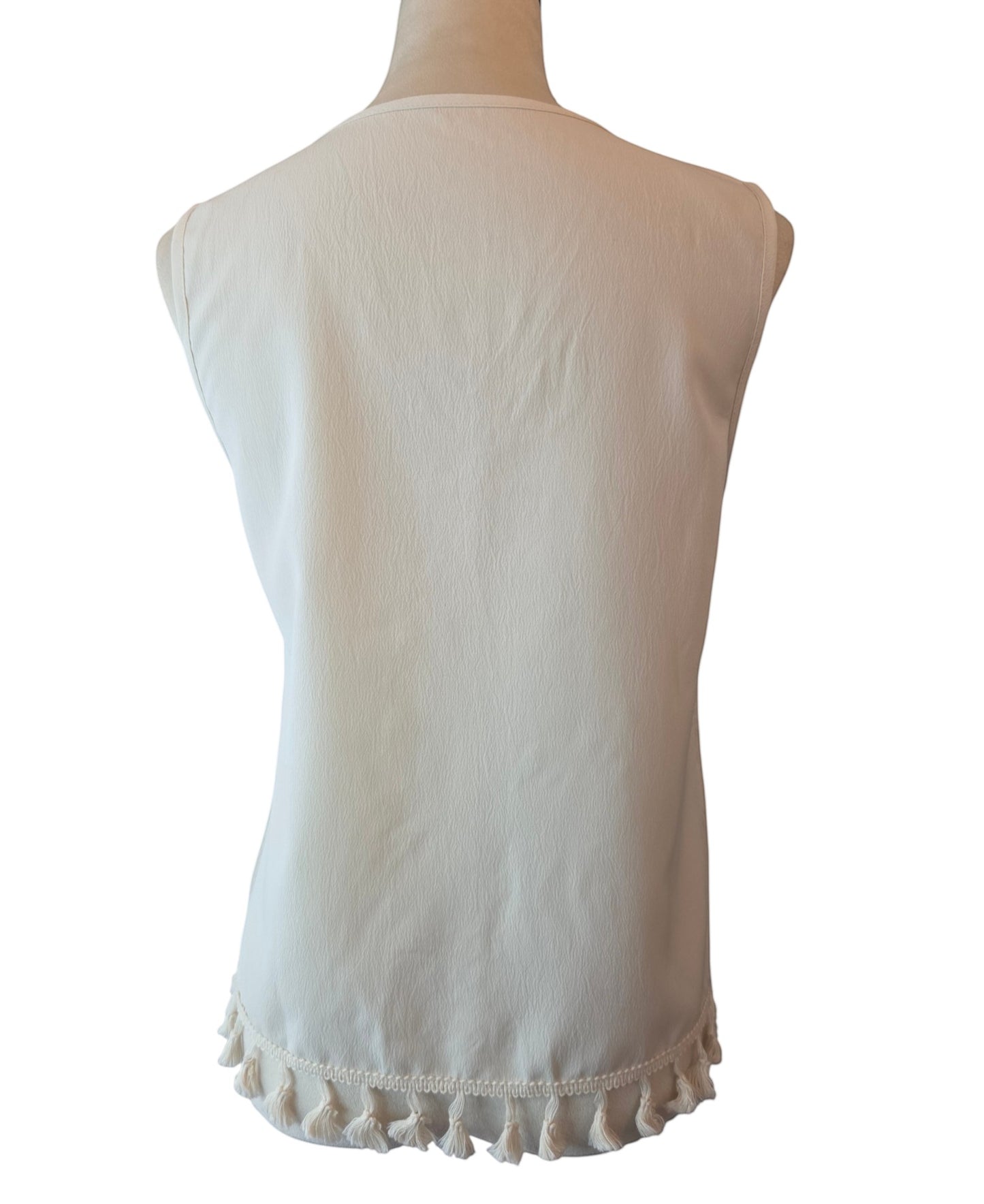 Back view of Birds of a Feather Boutique & Soy Wax Candle Company cream sleeveless blouse with tassel hem