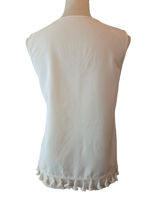 Back view of Birds of a Feather Boutique & Soy Wax Candle Company cream sleeveless blouse with tassel hem