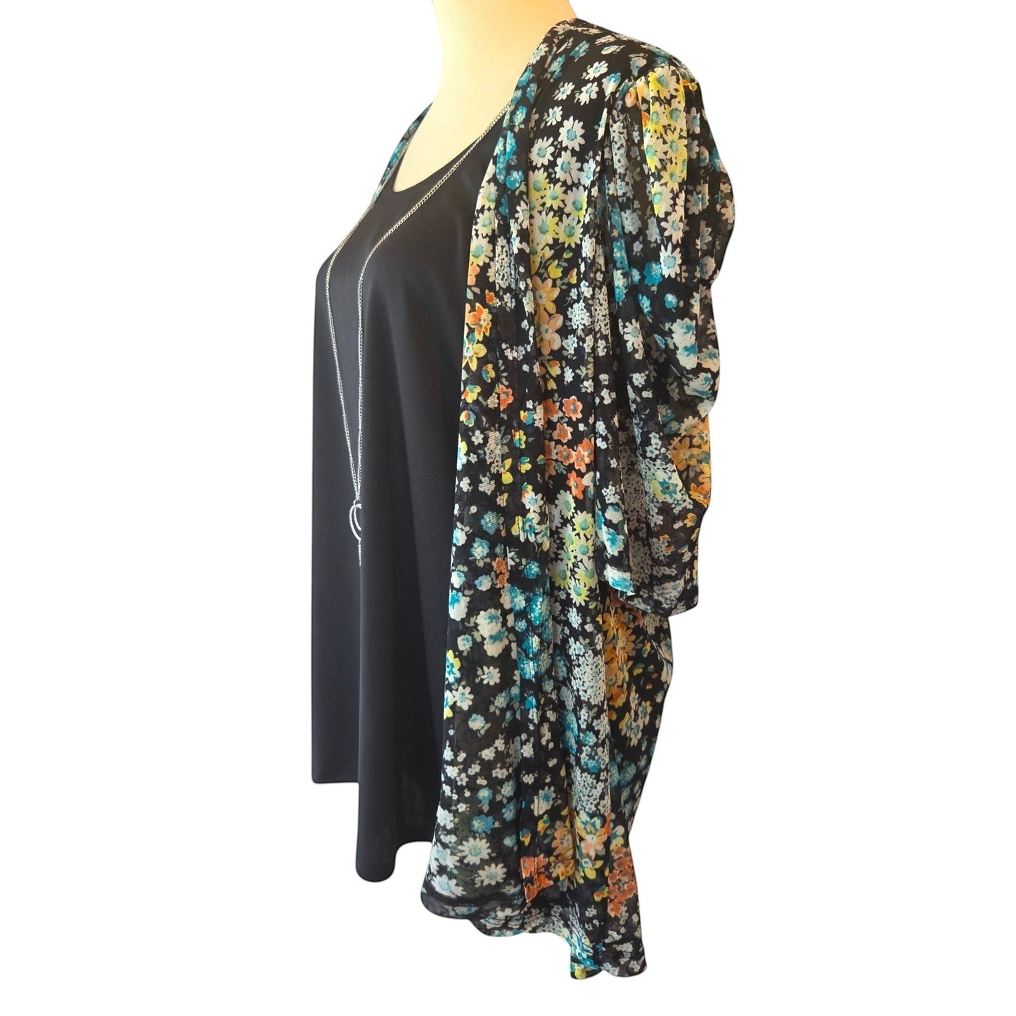 Birds of a Feather Boutique & Soy Wax Candle Company floral one-piece blouse with black tank and included necklace.